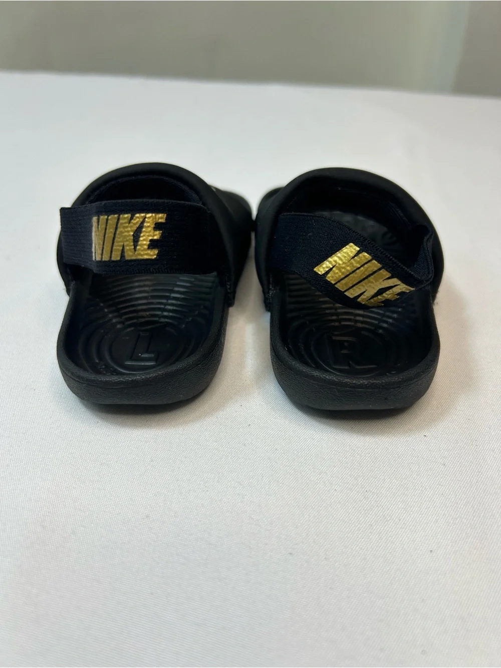 Nike Kids Black Slides with Gold Swoosh and Elastic Heel